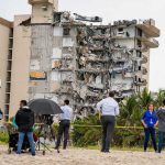 Indonesia Earthquake: 7.7 Magnitude Triggers Tsunami Warning Partially collapsed beachfront apartment building with onlookers