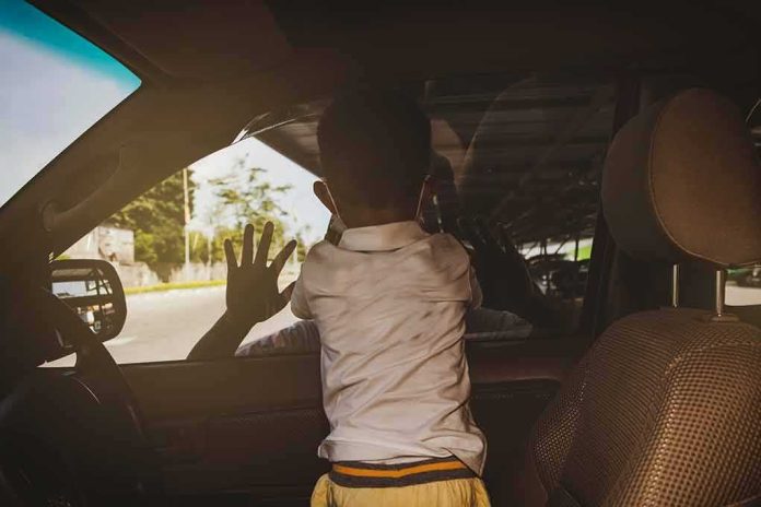 Child leaning on car window from the back seat