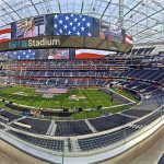 Football stadium interior with large video board and empty seating