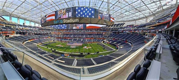 shutterstock_2135248363 Football stadium interior with large video board and empty seating