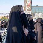 Vanishing Supreme Leader Sparks Panic Women in black veils standing in a crowded outdoor gathering