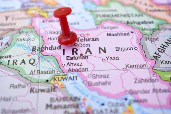 shutterstock_2237379503 Red pushpin on a map of Iran