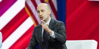 Stephen Miller speaking on stage during a panel discussion