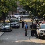 Ukraine’s Security Agencies Exchange Gunfire Police officers secure a residential street with patrol cars and yellow tape