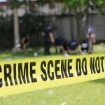 Flaming Cross Sparks Chicago Fury crime scene tape cordoning off a grassy area