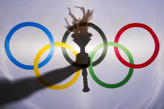 shutterstock_322328156 olympic rings with torch shadow