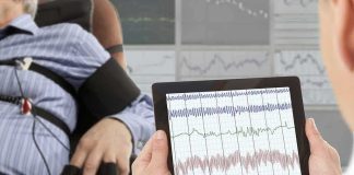 New Implant Creates Speech and Facial Expressions Technician reviews polygraph readings on a tablet beside a seated subject