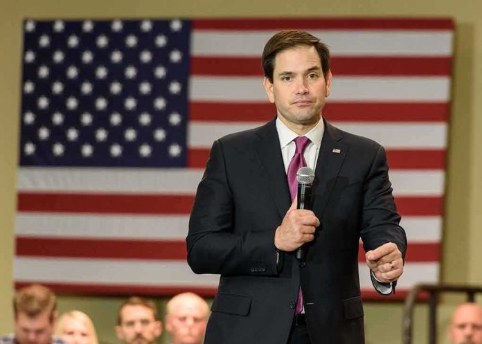 man in suit speaking into a microphone