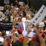 Trump Picks a Wildcard for Georgia Donald Trump speaks at a rally podium as a large crowd cheers; Orel Hershiser, Ion Marin, and Billy Joe DuPree present