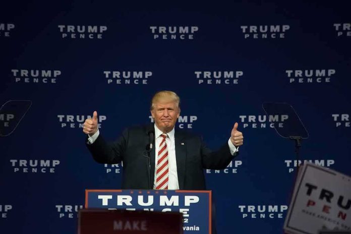 man at podium giving two thumbs up