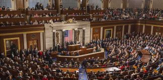 Capitol Hearing Halted Over Message Shirts Legislative chamber filled with attendees during a formal address