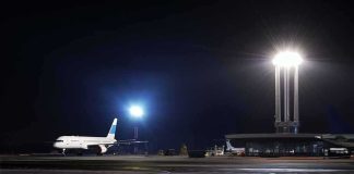 Airliner on a dimly lit airport tarmac at night
