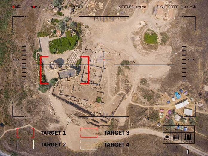 Aerial view through drone HUD of archaeological ruins and surrounding campsite