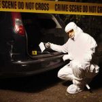 117 MPH Crash Leaves 2 Teens Dead forensic investigator at car trunk behind crime scene tape