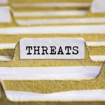 Hidden Strains Behind US-Taiwan Arms Pause index tab labeled threats in a filing organizer