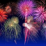 Fireworks exploding in colorful bursts against a dark night sky