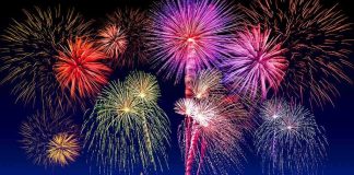 Fireworks exploding in colorful bursts against a dark night sky