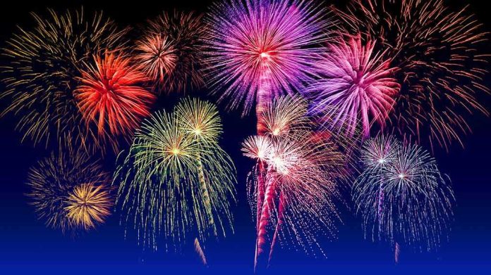 shutterstock_540609745 Fireworks exploding in colorful bursts against a dark night sky