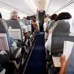 Flydubai Flight Diverts After Cockpit Struggle Airplane cabin with passengers seated in rows