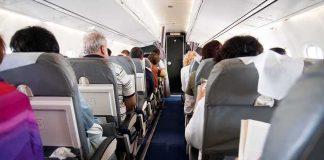 Flydubai Flight Diverts After Cockpit Struggle Airplane cabin with passengers seated in rows