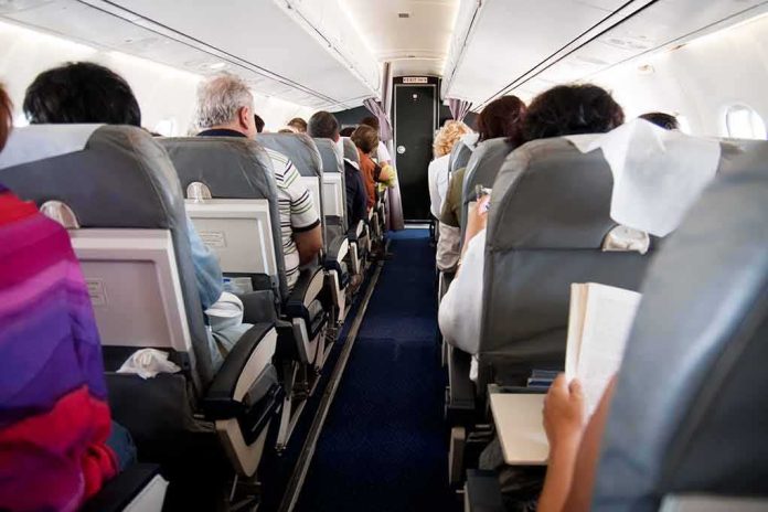 shutterstock_54660310 Airplane cabin with passengers seated in rows