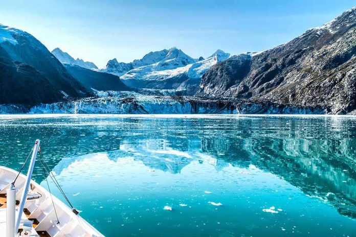 Boat approaching a glacier in a turquoise fjord