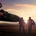 The Pilots Who Were Ready to Die Two pilots walking beside a fighter jet at sunset