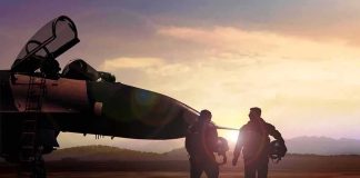 The Pilots Who Were Ready to Die Two pilots walking beside a fighter jet at sunset