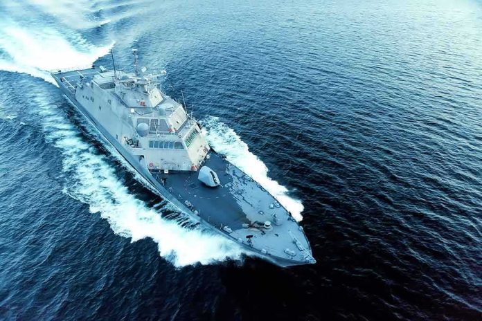 Naval warship cutting through open sea