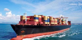 Container ship carrying stacked cargo at sea