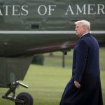 Trump Blends Ireland Diplomacy With Doonbeg Visit man walking beside a helicopter on a grassy field