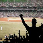 DOJ Slams MLB Over Pride Night Push Crowd of fans cheering at a baseball game in a stadium