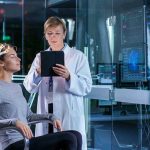 Brain Signals Twist: Faces Blur In Autism Patient wearing EEG cap sits while clinician reviews data on tablet