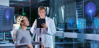 Brain Signals Twist: Faces Blur In Autism Patient wearing EEG cap sits while clinician reviews data on tablet