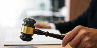 Judge Halts Deportation of Shot Man Judge's hand holding a gavel over a sound block