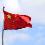Chinese Workers Face Unpaid Wages Chinese national flag waving on a flagpole