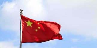 Chinese Workers Face Unpaid Wages Chinese national flag waving on a flagpole