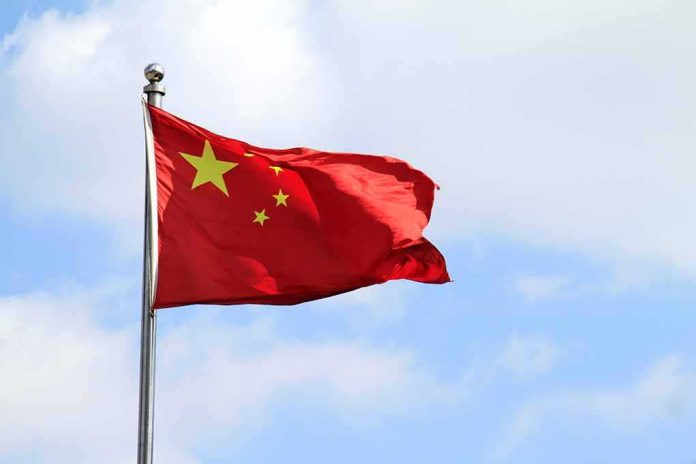 shutterstock_1060497302 Chinese national flag waving on a flagpole