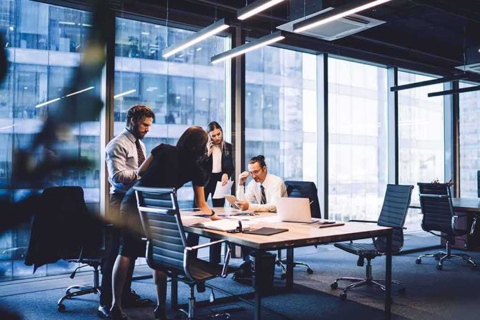 Business team collaborating at a conference table in a modern glass-walled office
