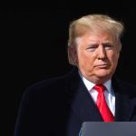 Trump Insults Reporter Over Controversial Campaign Ad Donald Trump at a podium with a microphone