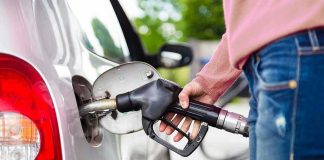 Iran Conflict Fuels U.S. Midterm Tensions Person fueling a car at a gas pump