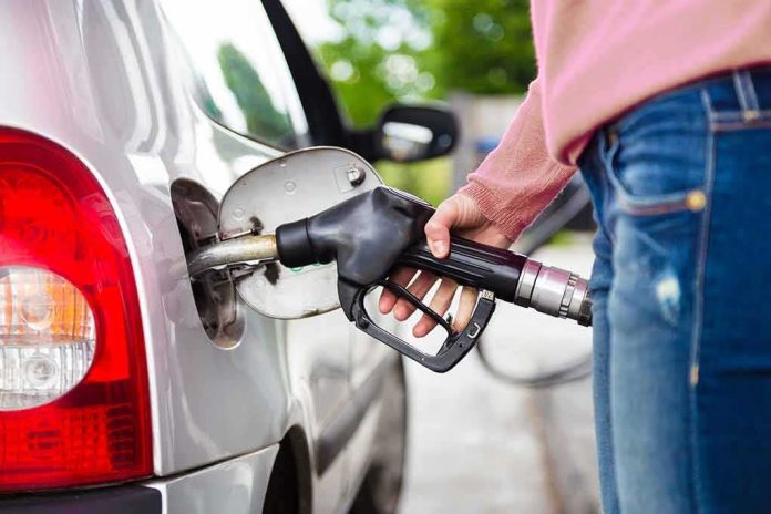 shutterstock_1723355350 Person fueling a car at a gas pump
