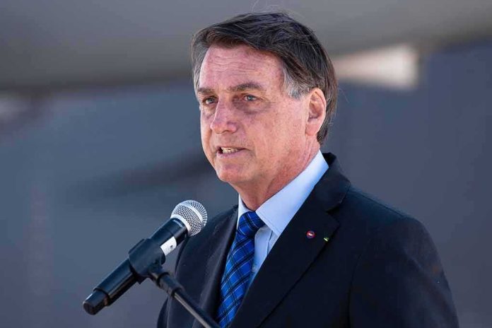 man in suit speaking at a microphone