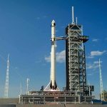 Japan Launches Mission to Bring Back Mars Moon Samples Rocket on launch pad under clear blue sky