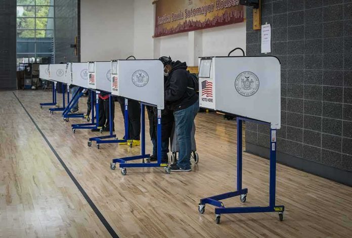 shutterstock_1846768891-2 Voters at polling booths in a gymnasium
