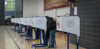 20,000 Voter Records Spark Legal Fight Voters at polling booths in a gymnasium