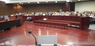Federal Charges Raise Accountability Questions Conference microphone on a podium in a courtroom