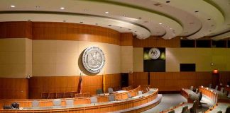 Wartime Tech Disruptions Raise Alarm Interior view of a government chamber with wooden paneling and seating