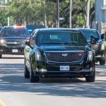 Trump Motorcade Races to Oklahoma Motorcade of black SUVs and sedans driving down a city street
