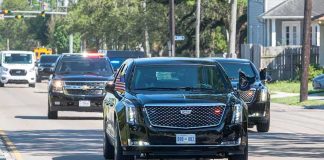Trump Motorcade Races to Oklahoma Motorcade of black SUVs and sedans driving down a city street
